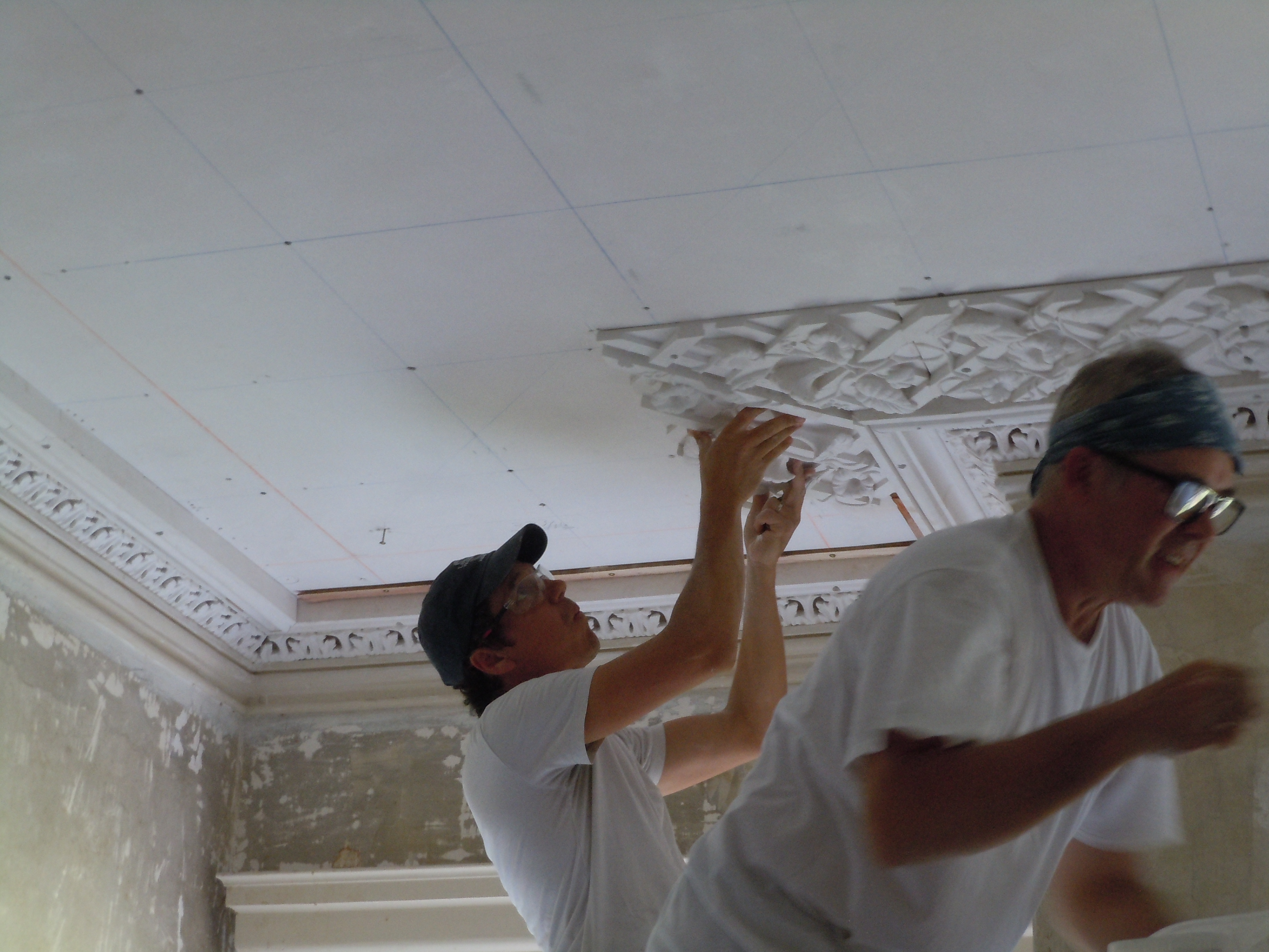  Greg Jacobs and Adam Chase of Landmark Preservation installing the perimeter plaster lattice in the front room.